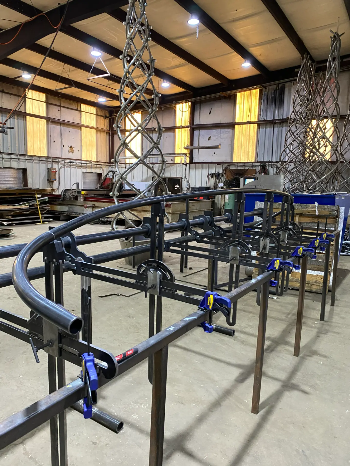 Curved tube clamped into the CAD-derived inspection fixture on the shop floor