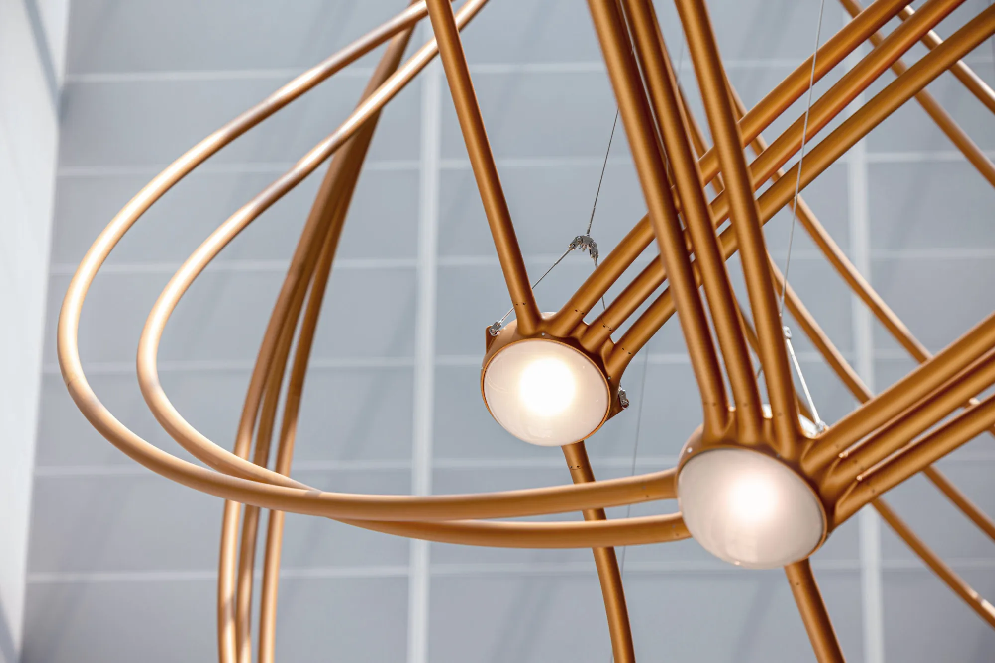Detail of glowing star nodes clustered where copper tubes converge