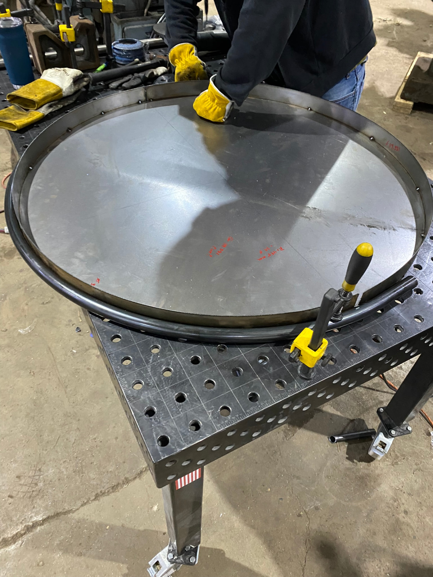 Pedestal base ring clamped to the welding table with its steel deck plate