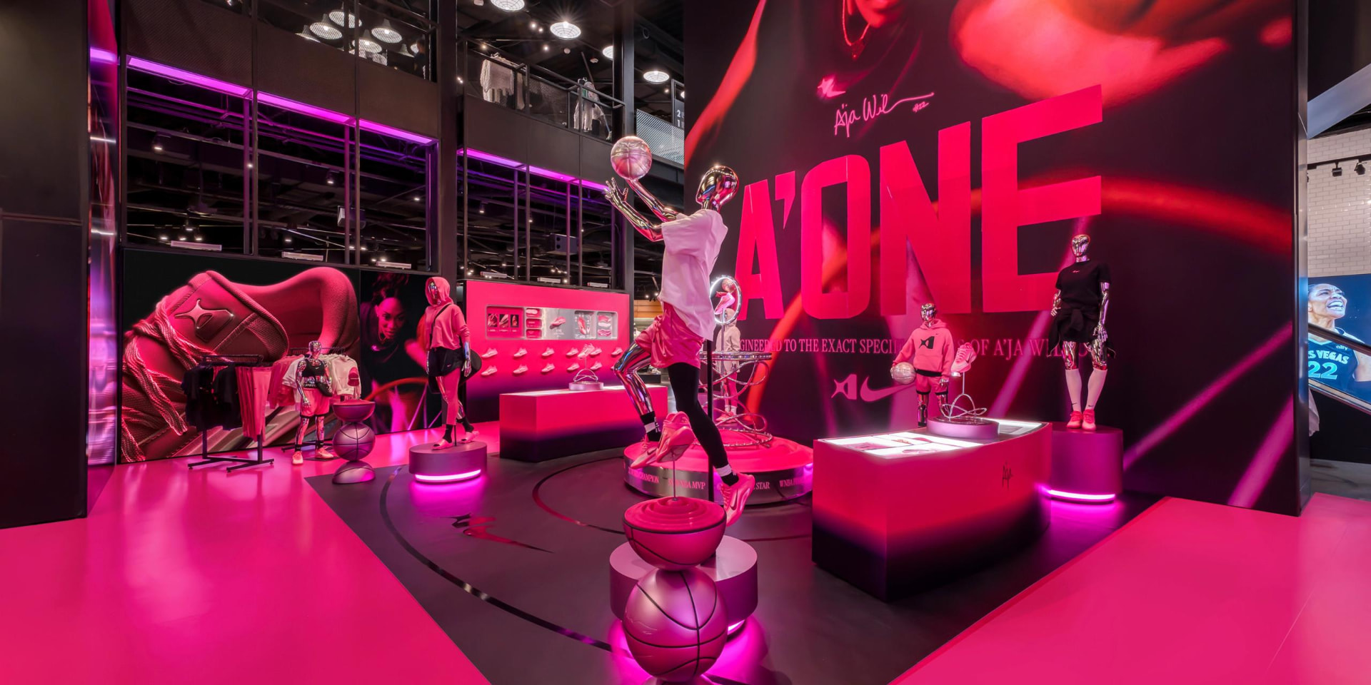 Angled view of the A'One retail environment with chrome mannequins and illuminated plinths