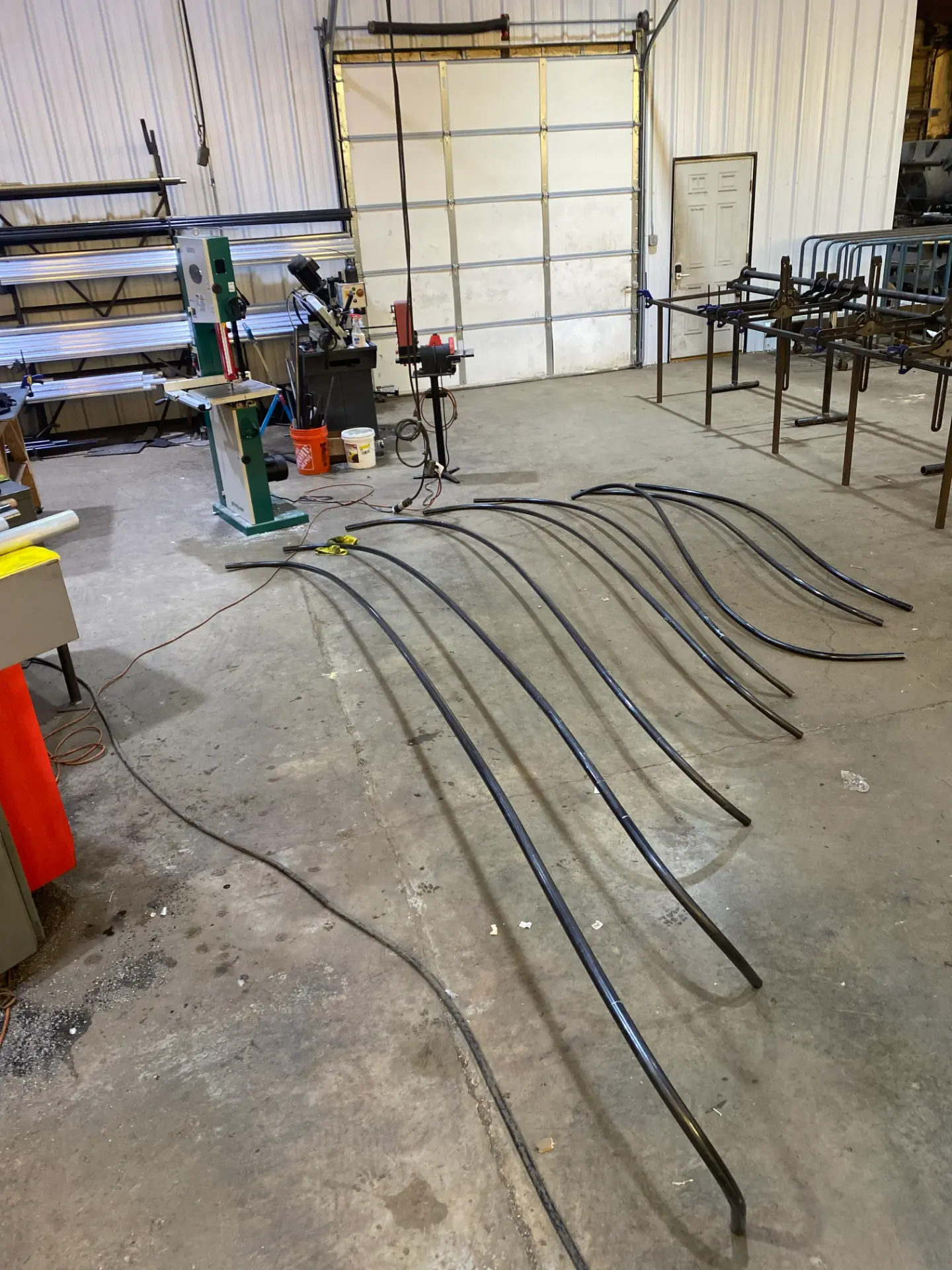 Long bent tube segments staged for inspection and fit-up in the fabrication shop