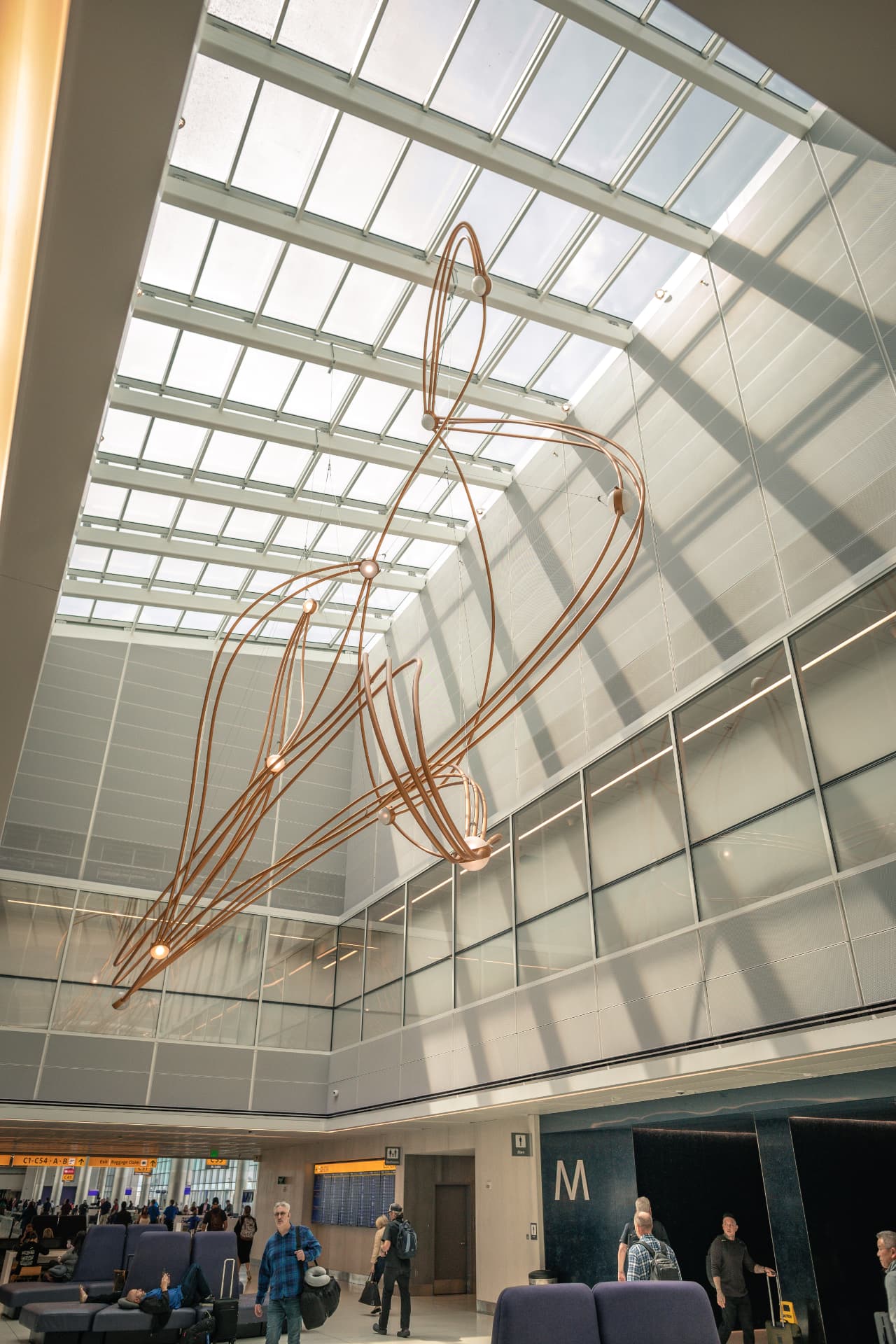 Constellations sculpture suspended beneath the terminal skylight in daylight