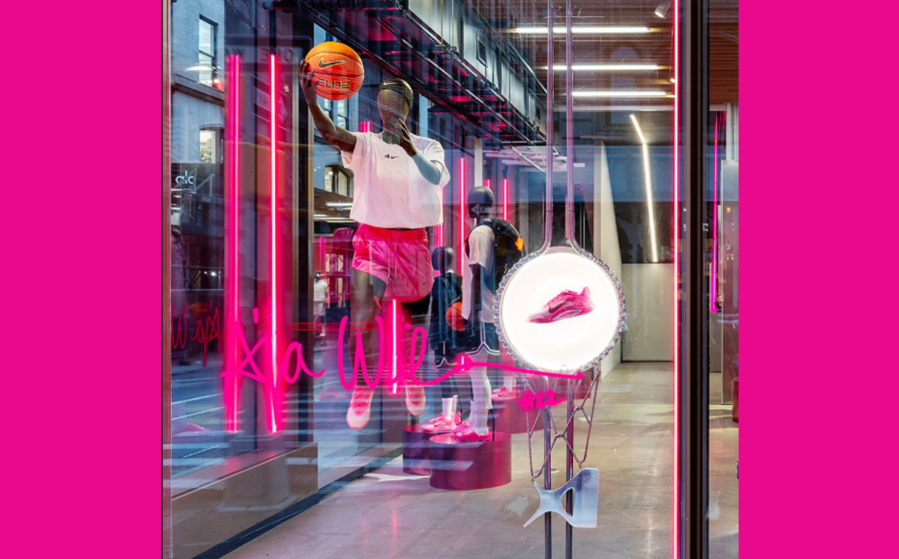 A'ja Wilson storefront window display with neon signature and lit shoe ring