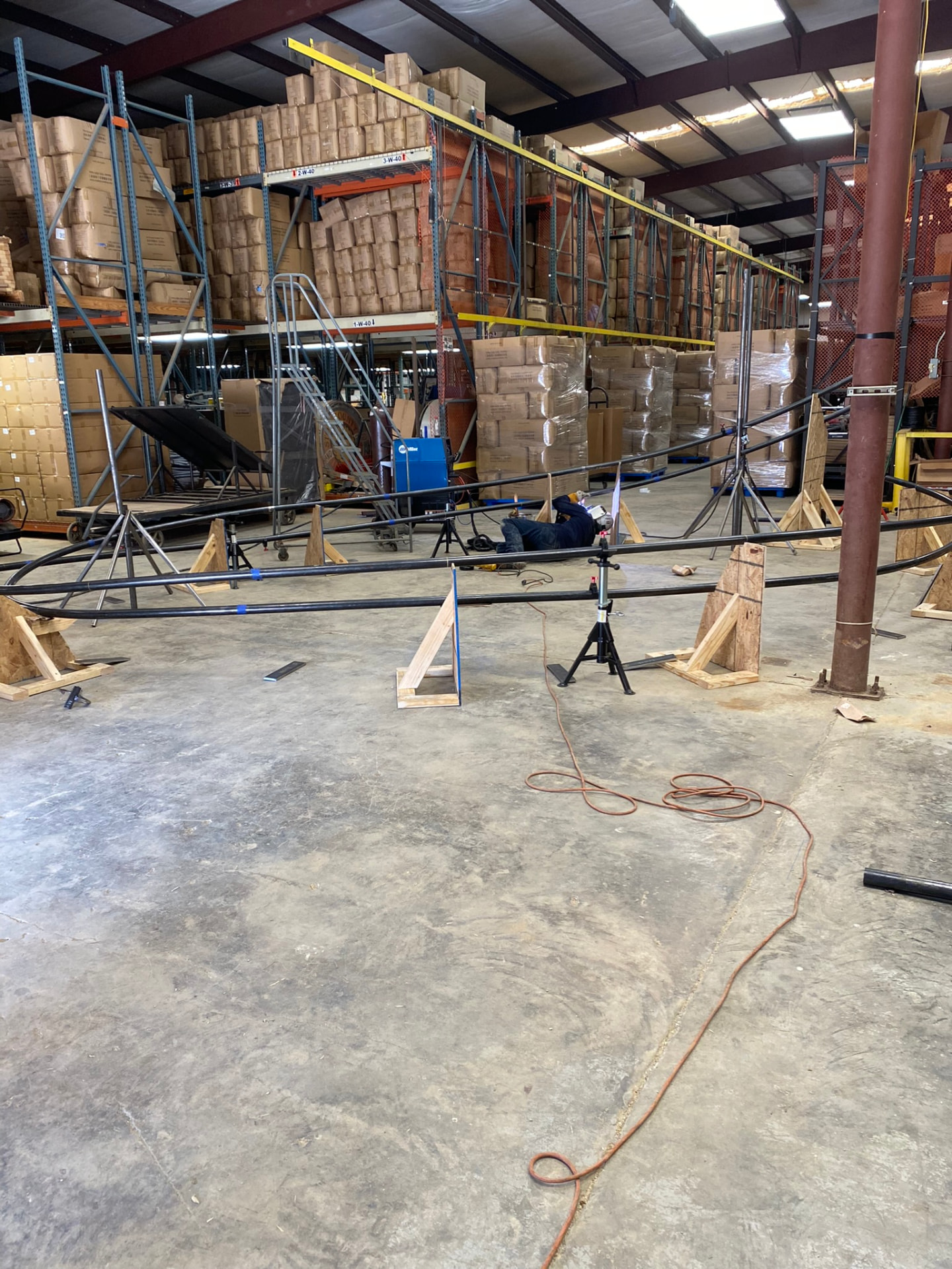 Full-length trellis assembly supported on stands during weld-out in the shop