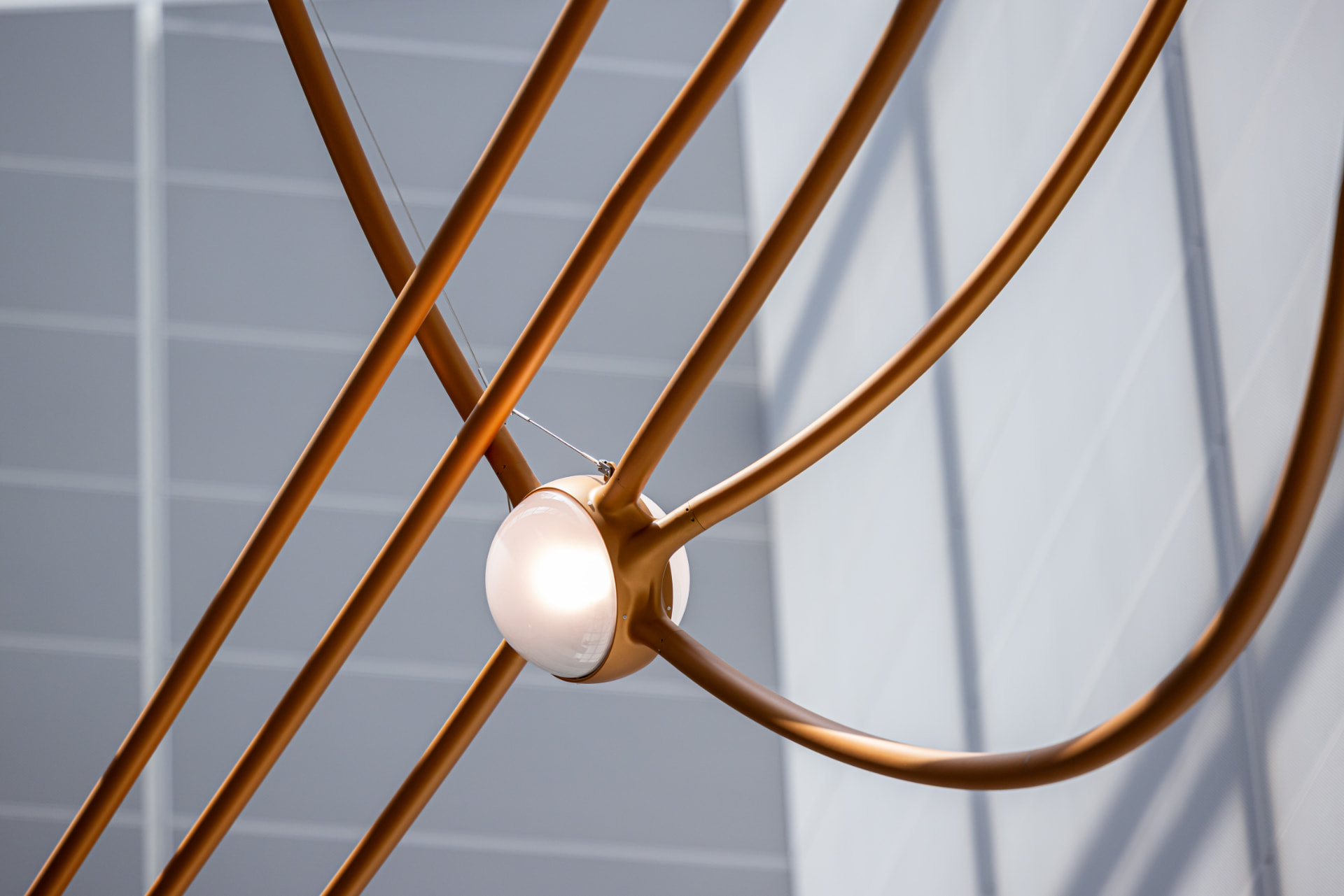 Close detail of a glowing star node where copper tubes intersect
