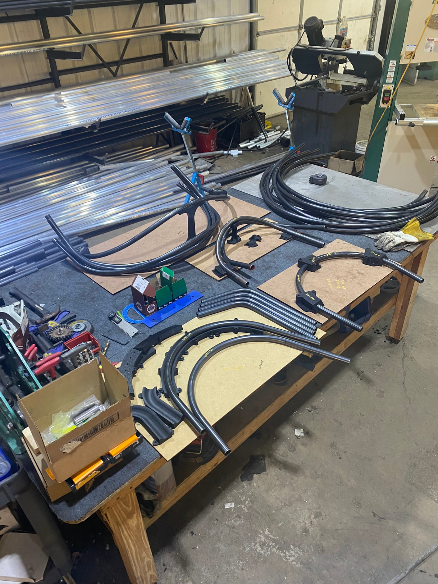 Wide view of the bent tube kit, jigs and raw stock in the fabrication shop