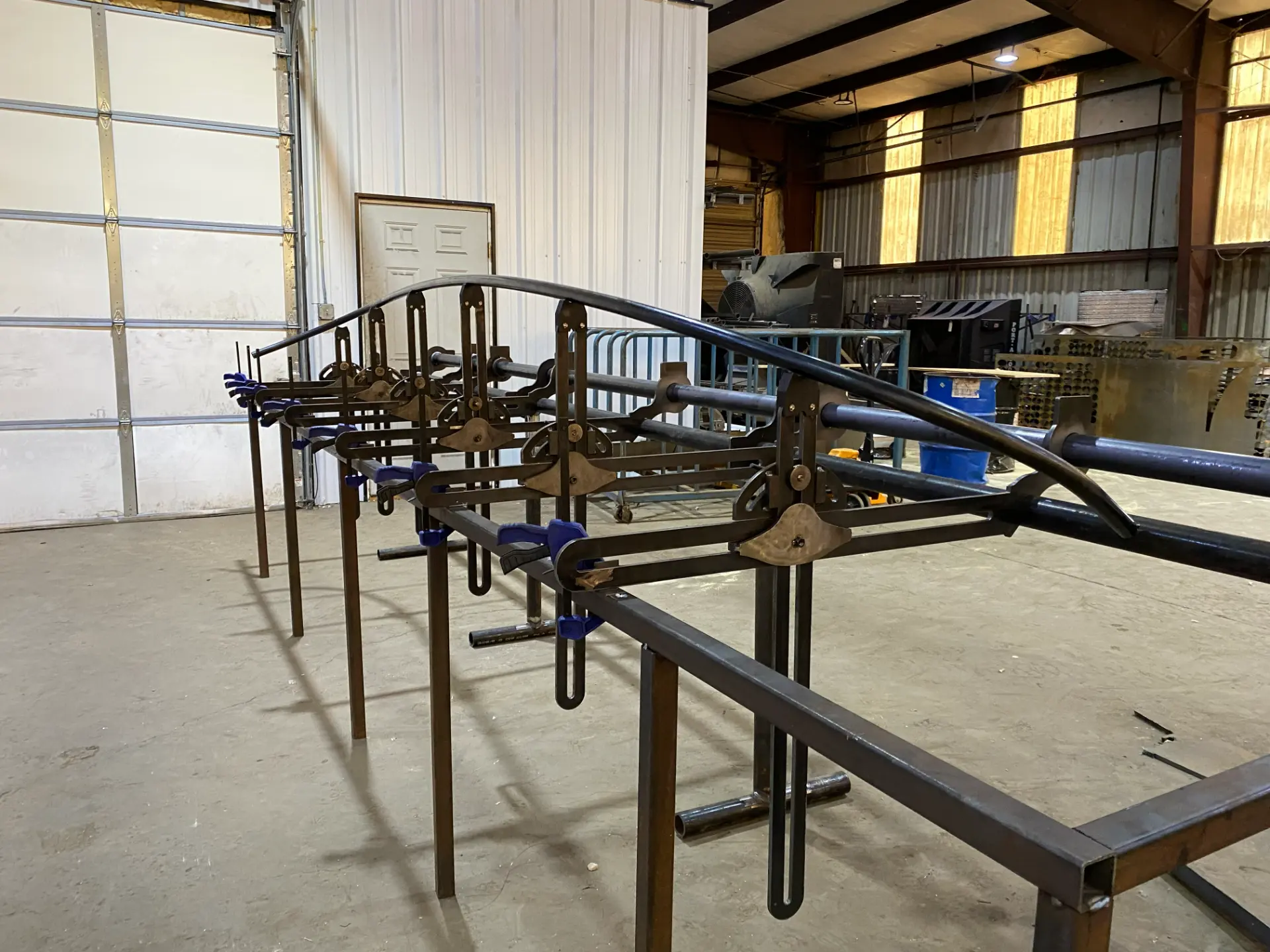 Bent tube section checked against the fixture's indexed saddles during production