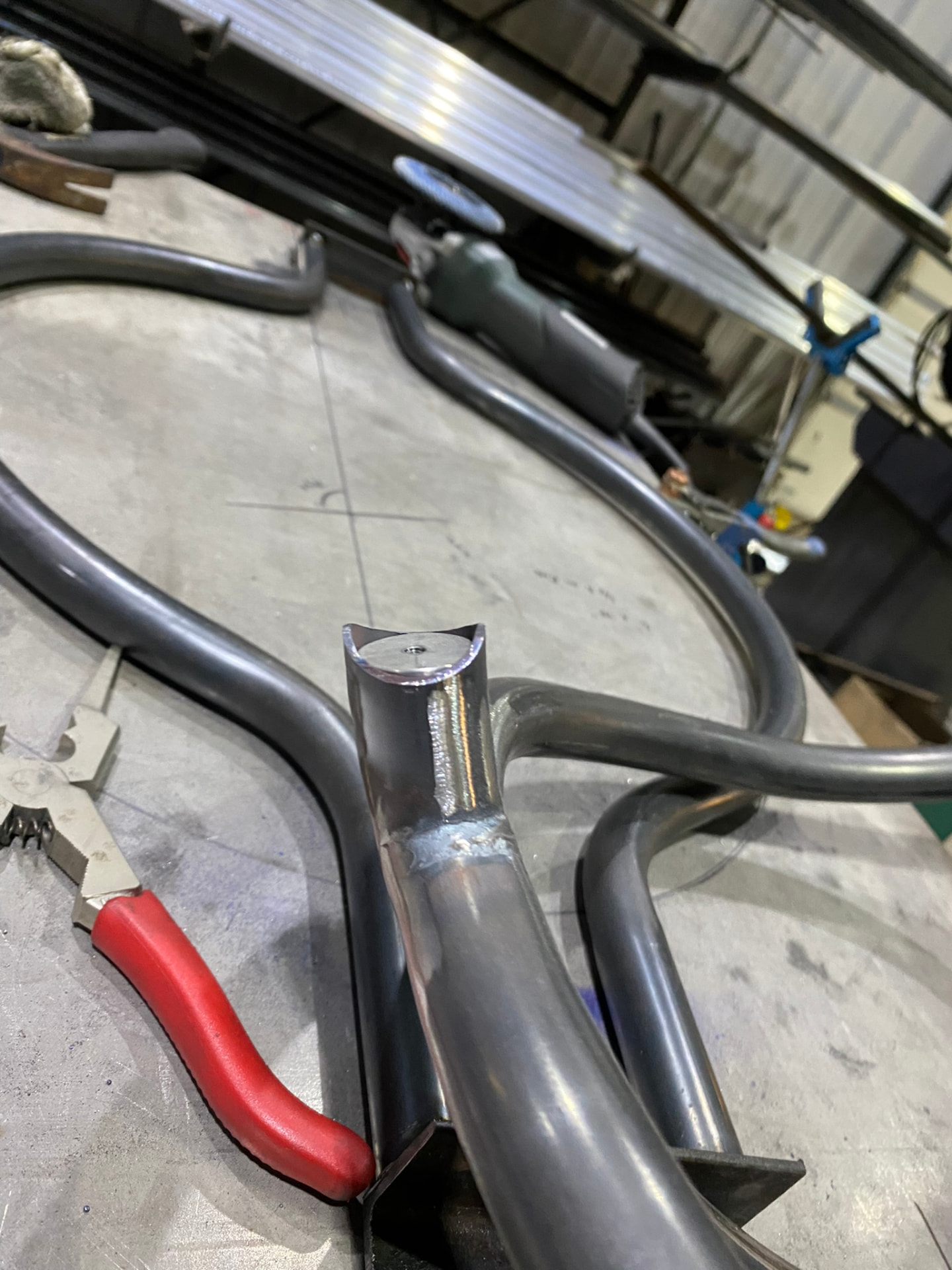 Close-up of a coped and welded tube intersection with machined saddle cap