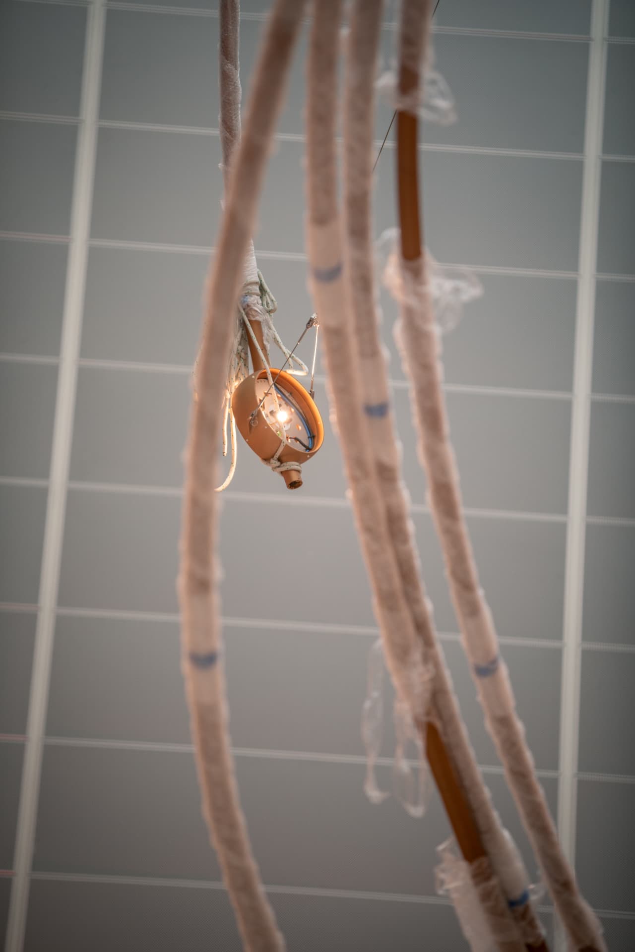 Lit star node glowing between wrapped copper tubes