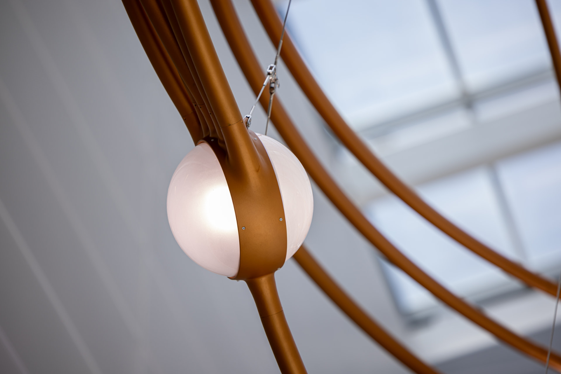Close view of a frosted glass star clasped by a copper collar