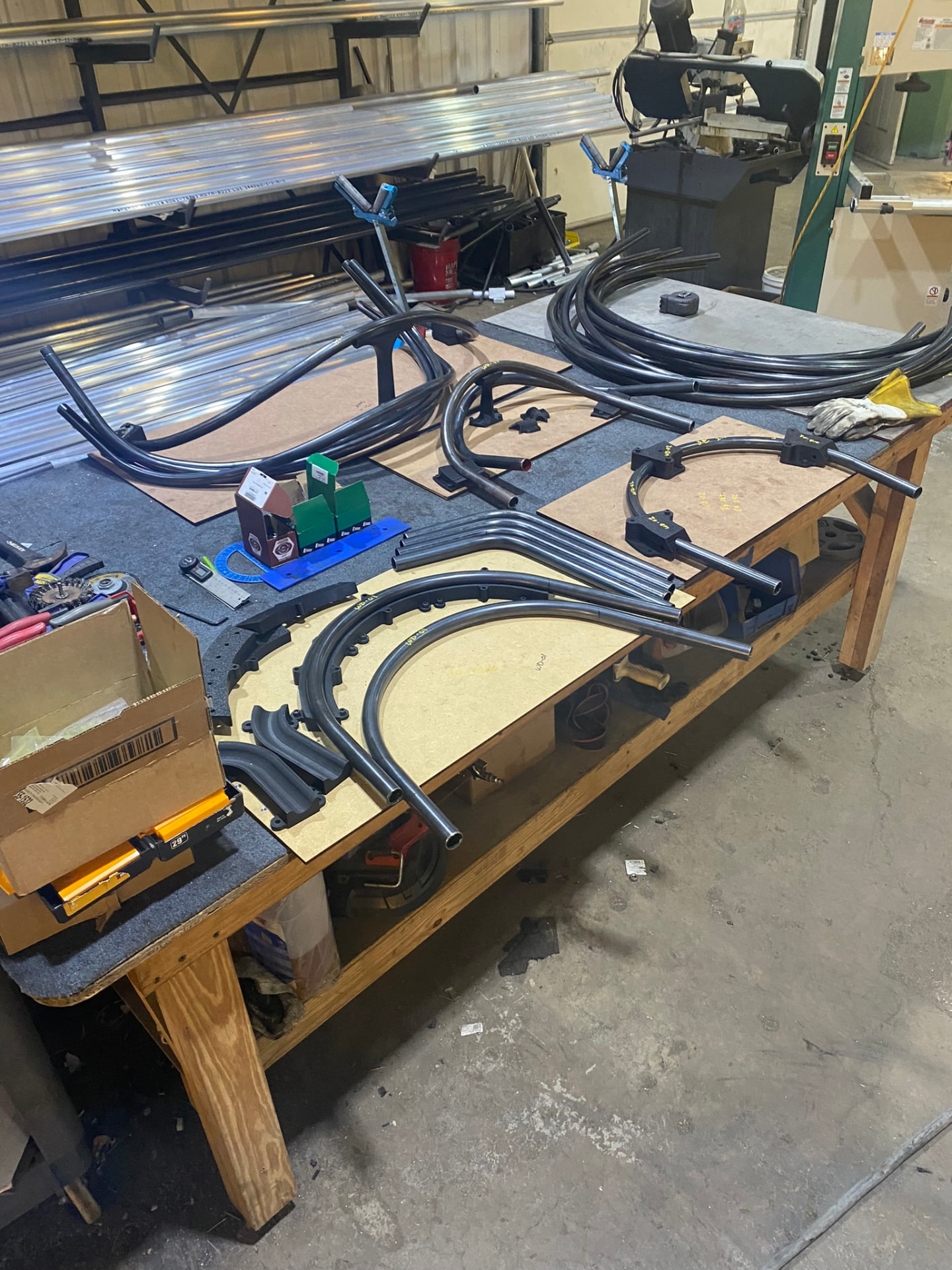 Full set of bent tube components staged across the shop bench