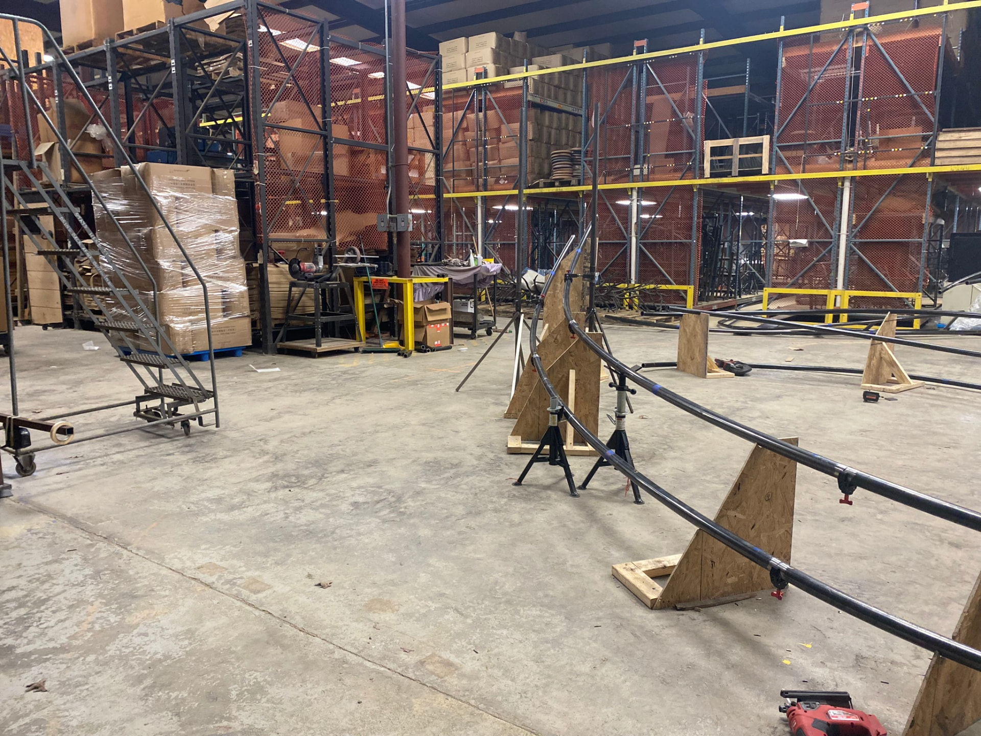 Curved trellis runners clamped to plywood fixtures set from CAD floor layouts