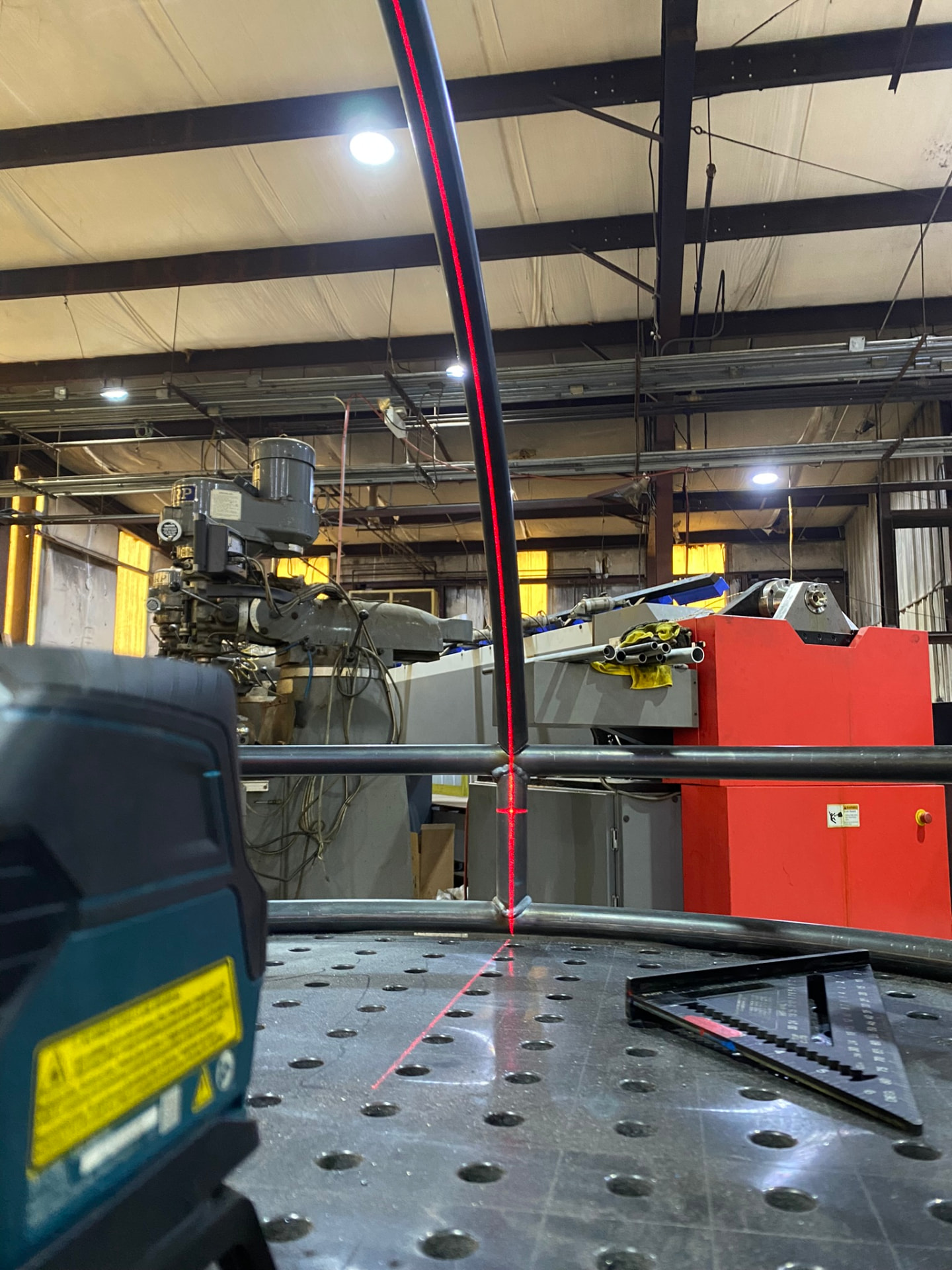Laser level used to plumb a pedestal arc over the fixture table
